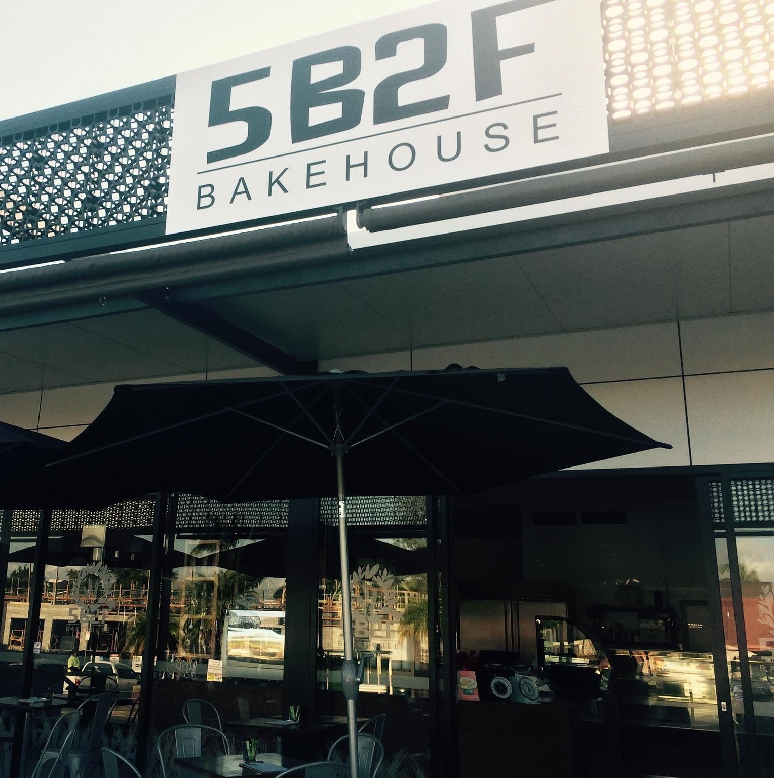 The 5B2F Bakehouse sign above the outdoor tables and umbrellas